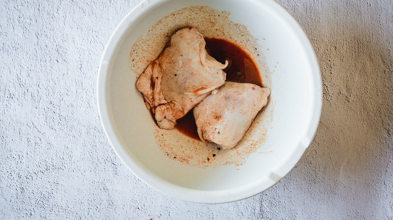 chicken thighs marinating in bowl 