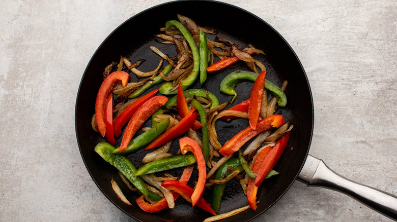 stir frying peppers and onions