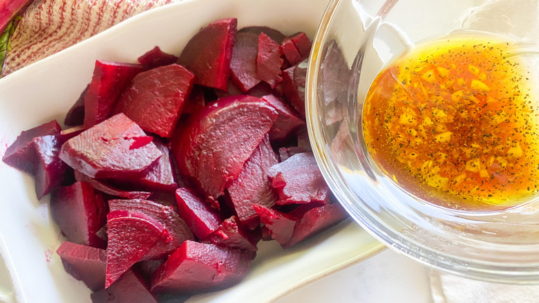 pouring dressing over cooked beets