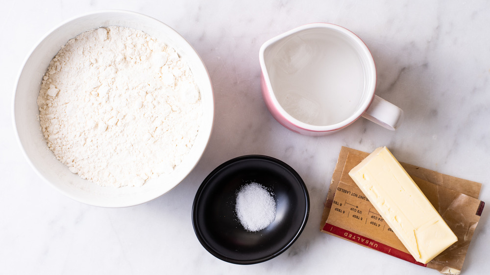 Ingredients gathered on a marble counter to make pie crust