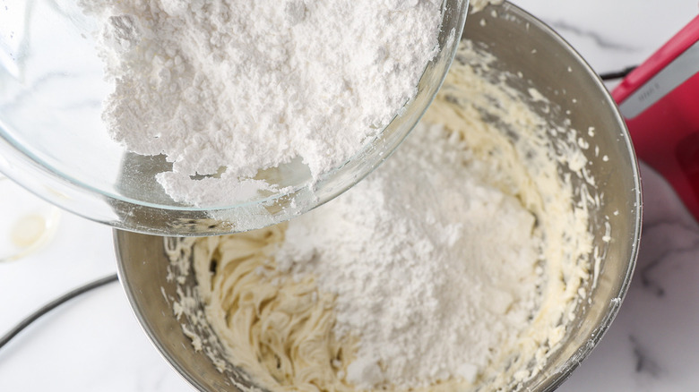 adding cake mix to bowl