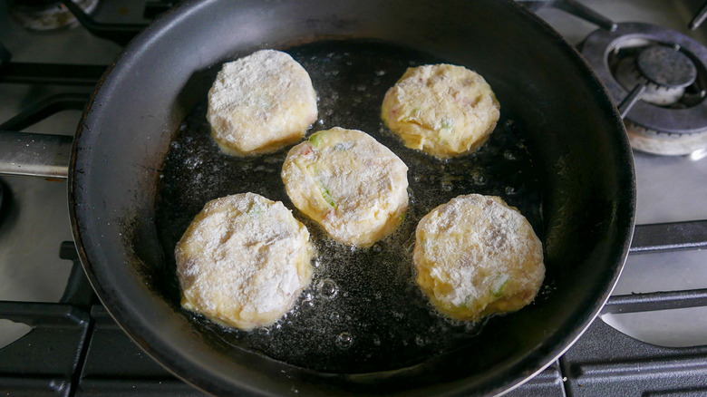 potato cakes in hot skillet 