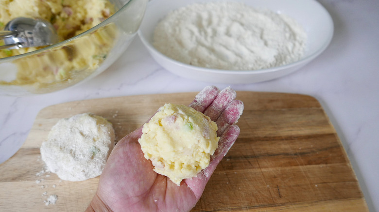 hand holding uncooked potato pancake