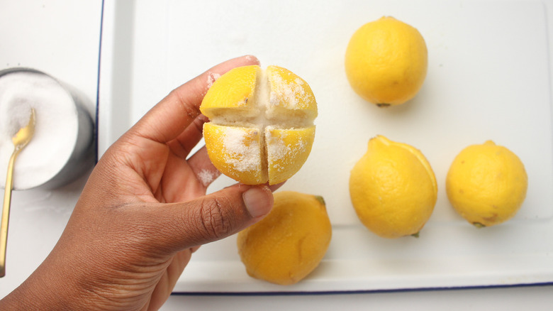 hand holding lemons with salt