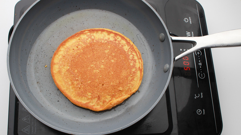 Easy Pumpkin Pancakes Recipe pancakes in pan 