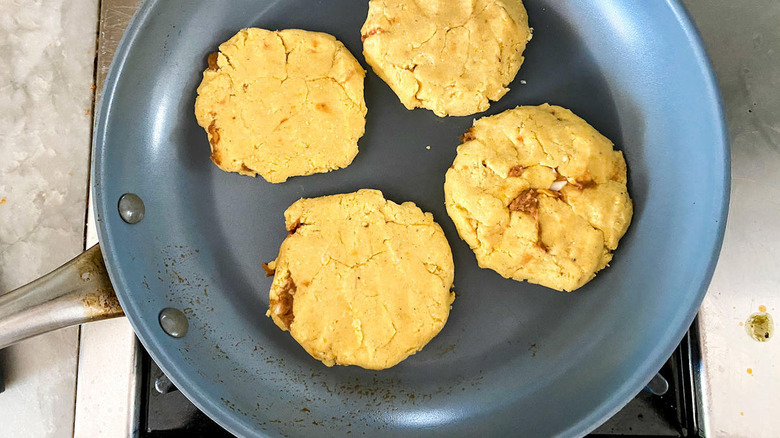 Uncooked pupusas in frying pan