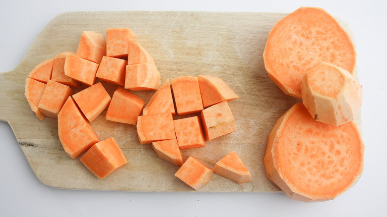 Sweet potatoes chopped on a board