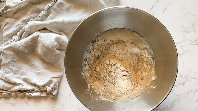 flour, milk, yeast, oil, salt in bowl