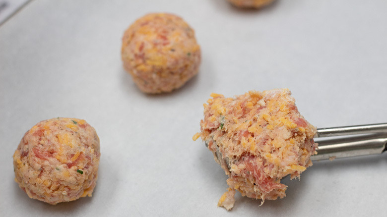 sausage meatballs on baking sheet