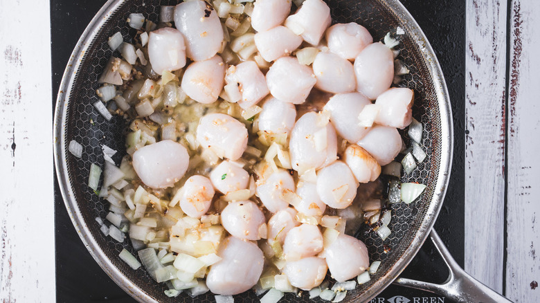 pan with onions, garlic and scallops