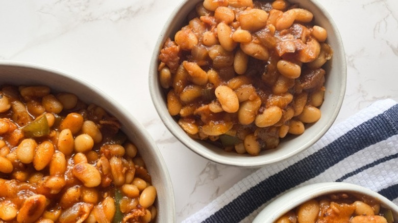 bowl of Instant Pot baked beans on a gray and white marble counter