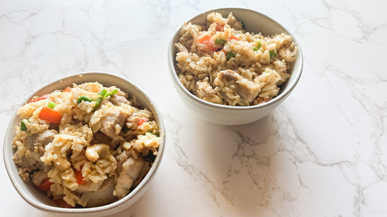 bowl of Instant Pot Thai fried rice with chicken bites, onion, red bell pepper, ginger, cashews, and scallions