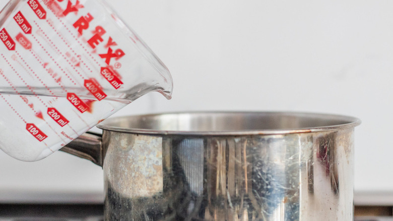 pouring water into pan