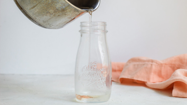 pouring syrup into jar