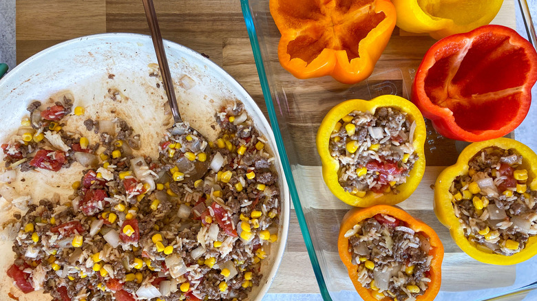 peppers being stuffed with filling