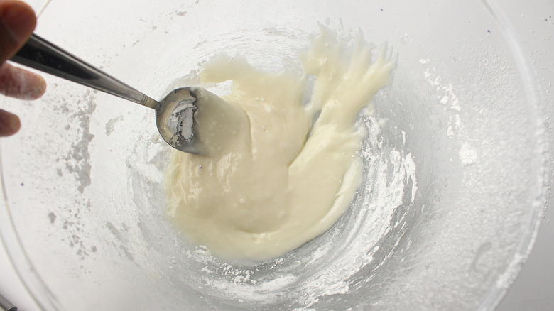 stirring frosting in bowl