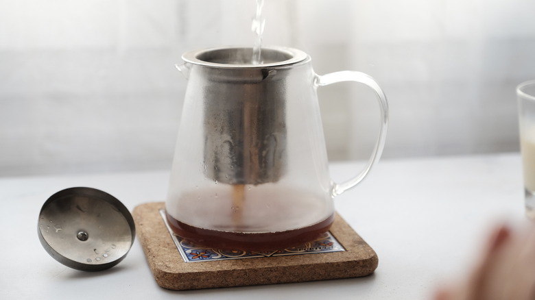 pouring water to infuse tea