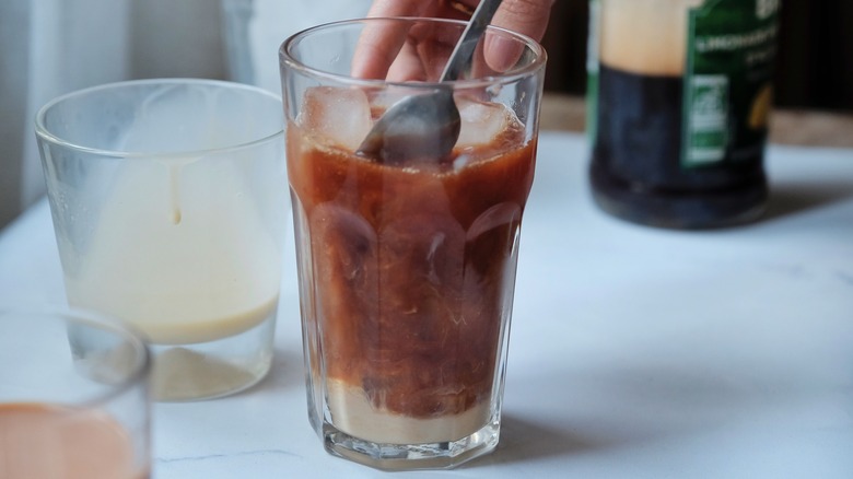 stirring thai tea with milk