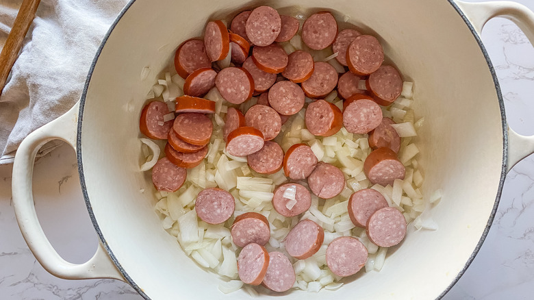 Onions and sausage in a large pot cooking