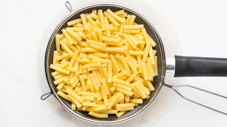 Cooked macaroni in strainer