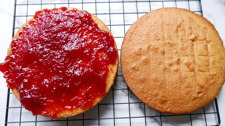 spreading jelly on cake