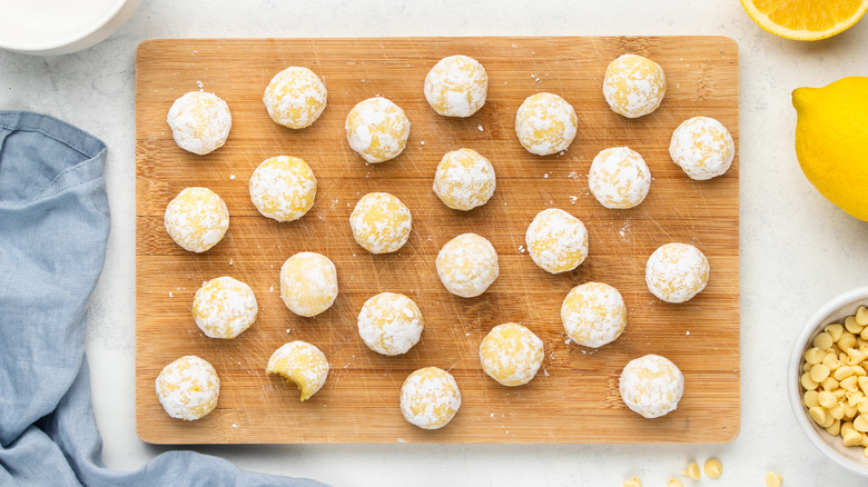 white chocolate lemon truffles on wooden board