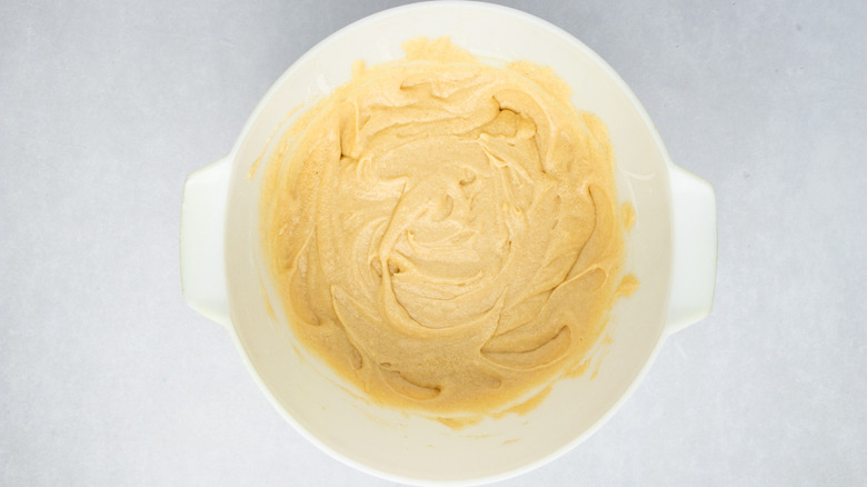 Yellow cake batter in white, handled bowl