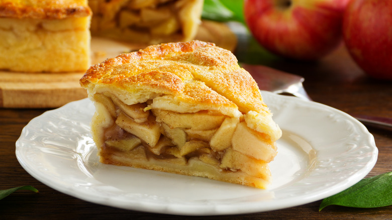 Slice of apple pie on a white plate.