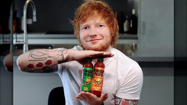 Ed Sheeran holding his hot sauce brand Tingly Ted's