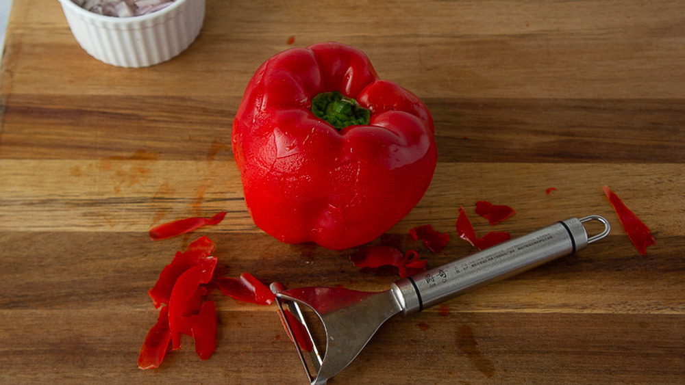 red bell pepper being peeled