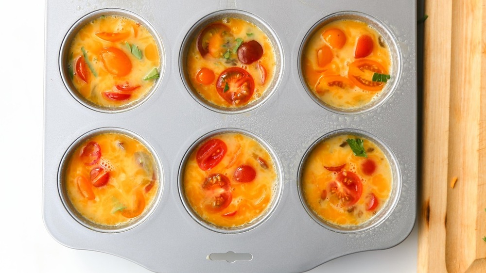 muffin tins filled with egg and veggies