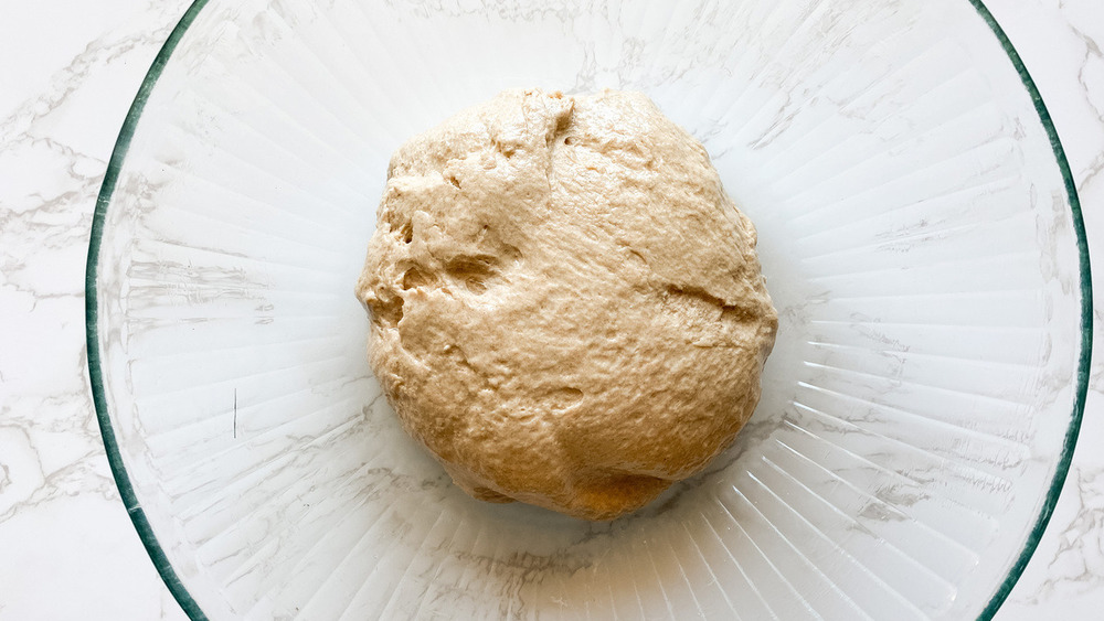 pizza dough in glass bowl