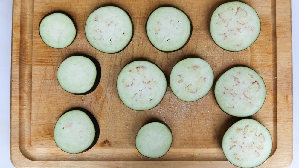 salted eggplant on cutting board for eggplant parmesan recipe