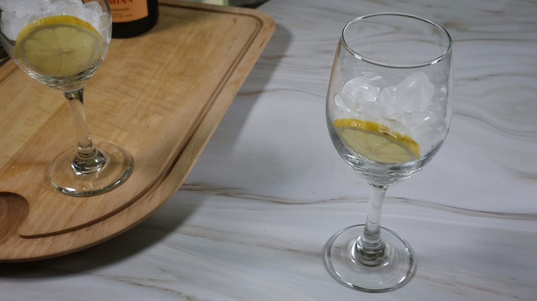 wine glass with lemon wheel and ice