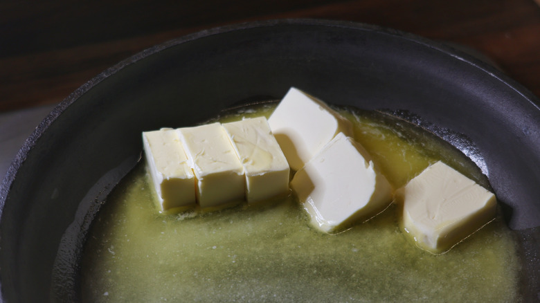 chopped butter melting in a skillet