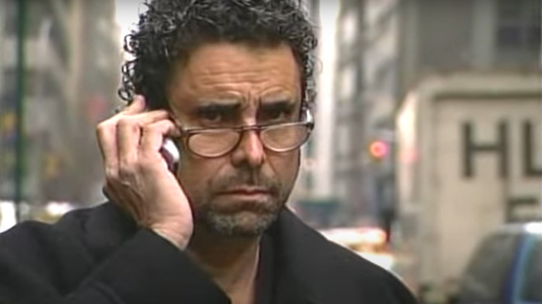 Jeffrey Chodorow on the phone wearing glasses with serious expression