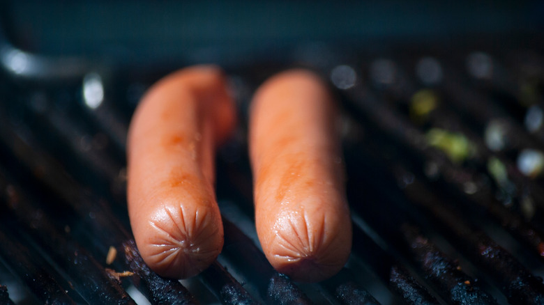 two hot dogs on a grill