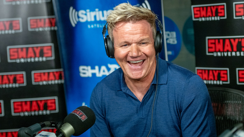 Gordon Ramsay smiling in headphones