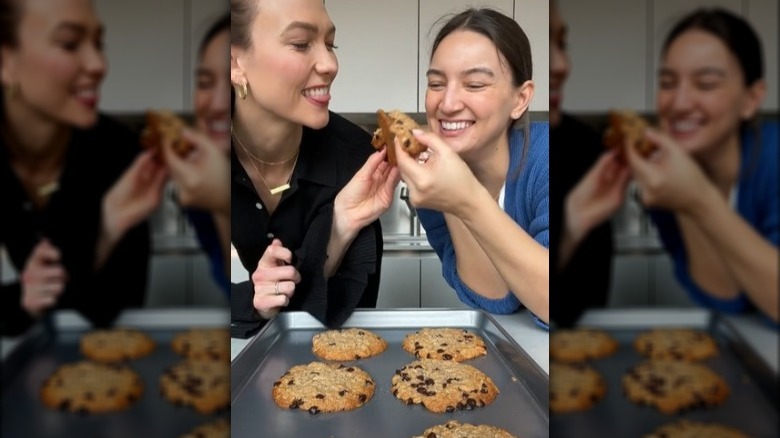 Karlie Kloss and Emily Mariko sharing a cookie