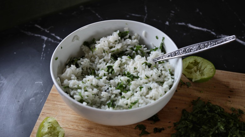 bowl of rice with limes and cilantro