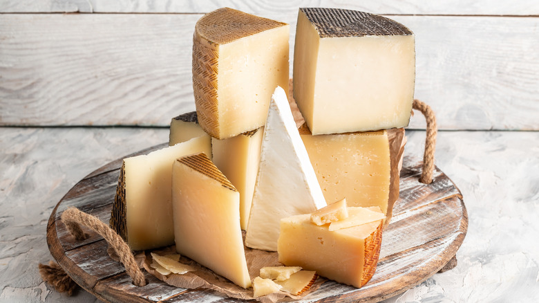 Various cheeses on wooden board 