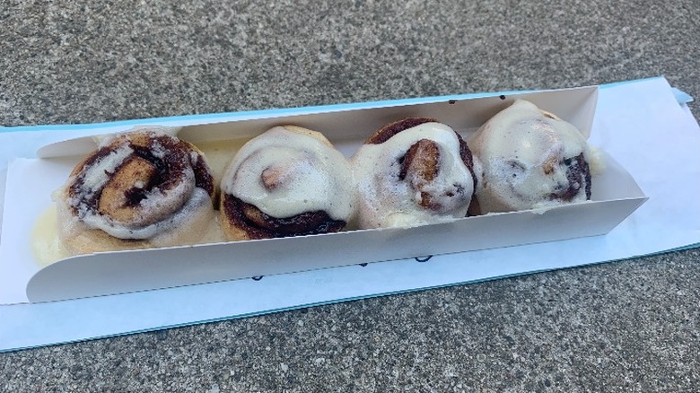 Four small cinnamon rolls in a box