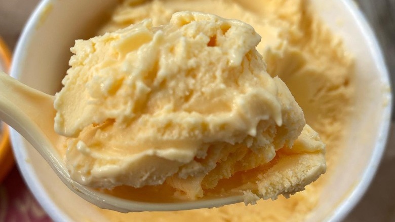 orange ice cream on spoon