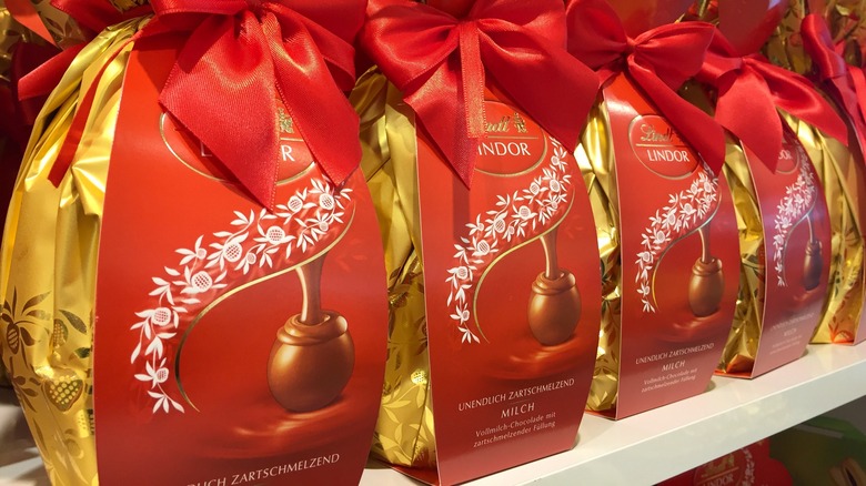 gold bags of lindor truffles tied with red ribbons