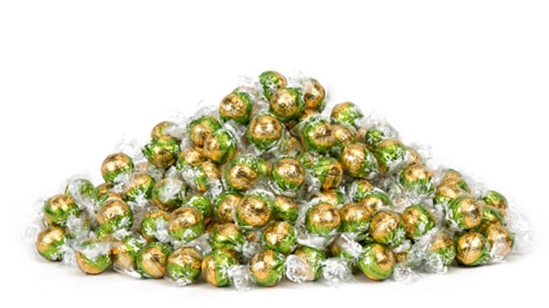 Green and gold chocolate truffles in a large pile