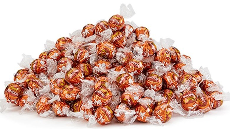 Pile of orange red foil covered truffles