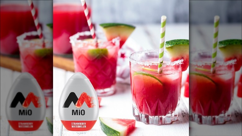 MiO Strawberry Watermelon container next to drinks in glasses with straws