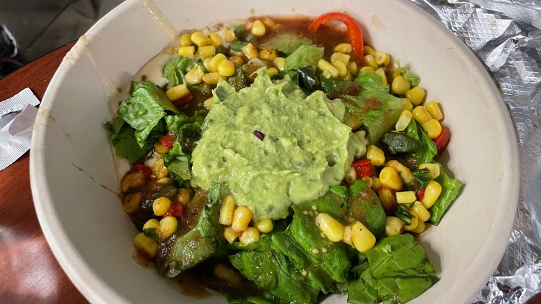 nacho toppings in a cardboard bowl