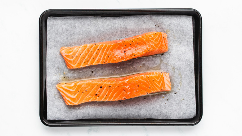 salmon fillets on baking sheet