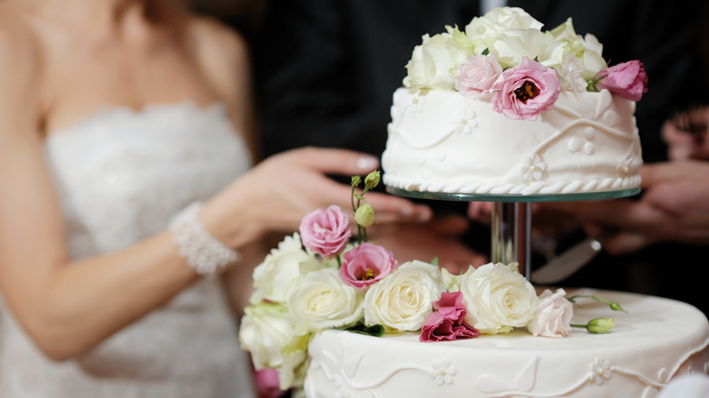 Bride cutting a wedding cake